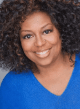 Smiling person with curly hair in blue.